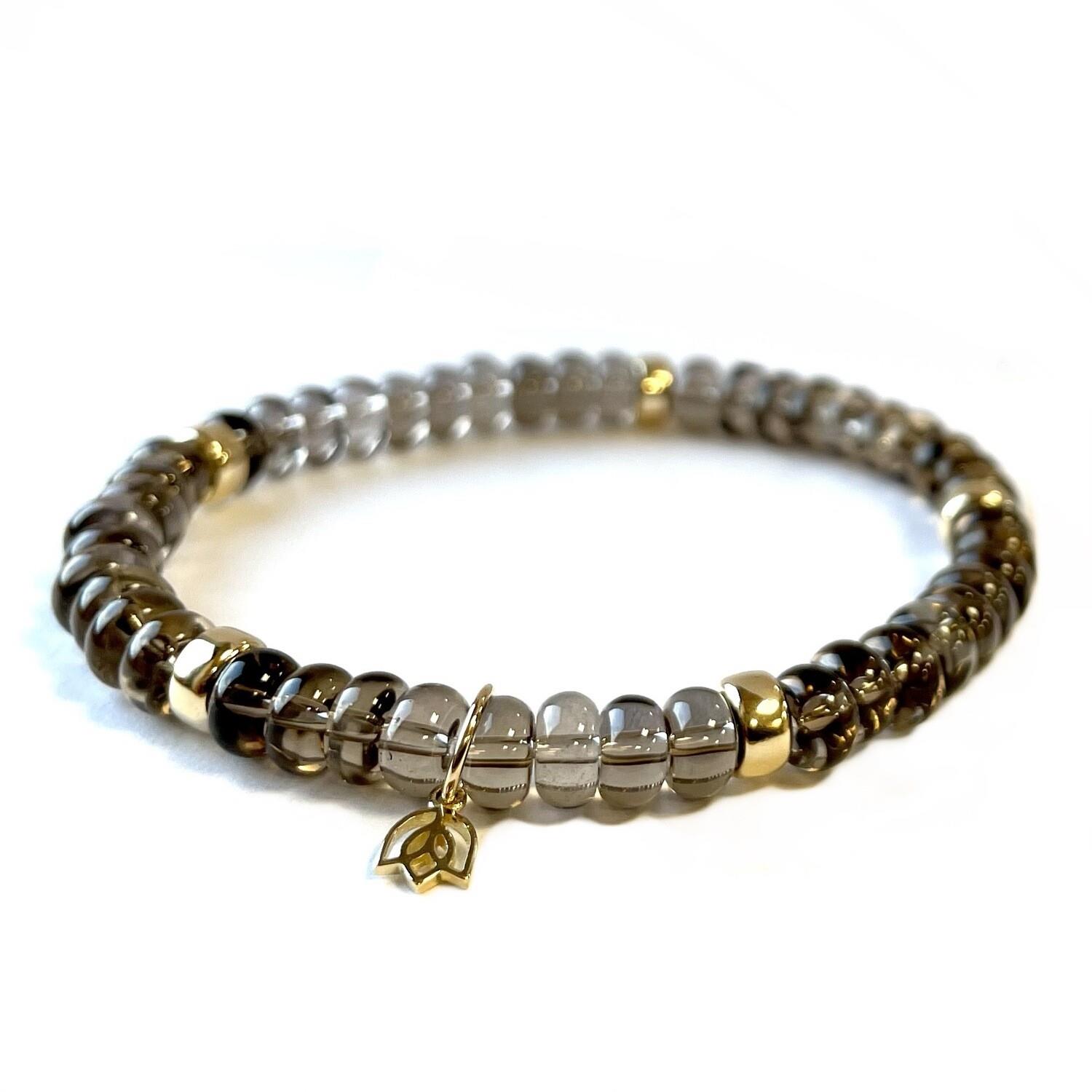 Y&G Edelsteen armband met tea Kwarts
Edelstenen armband (6x4mm kralen) en Vijf 14 krt gouden beads & tulp logo.
