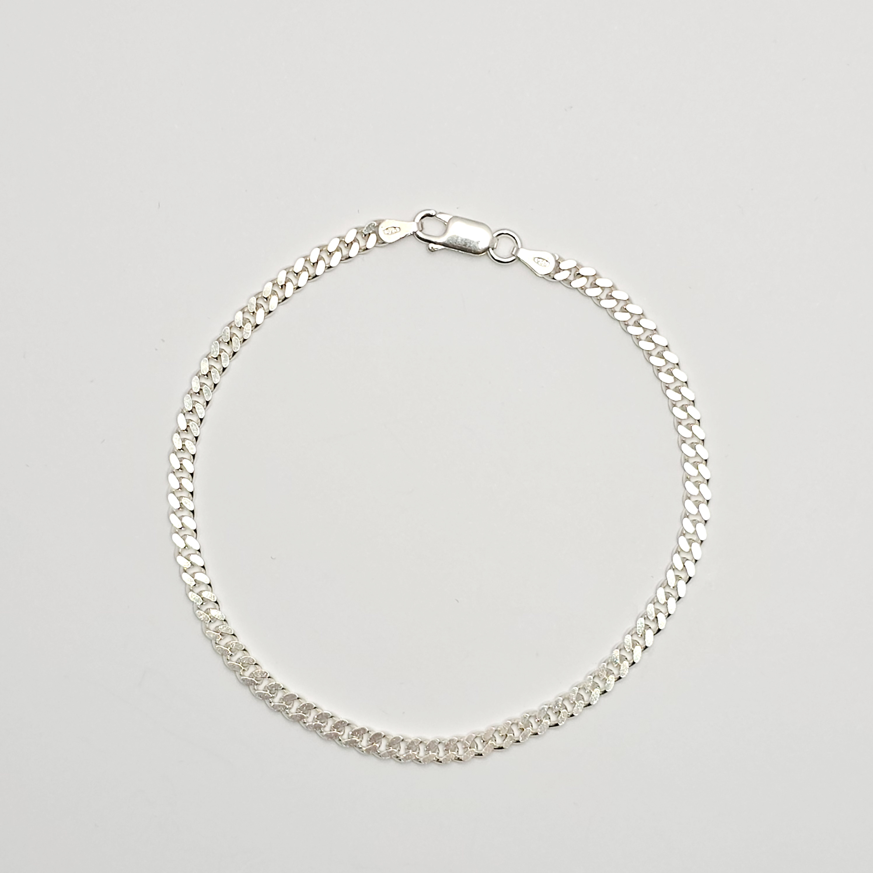 Zilveren armband in platte gourmet schakel, lengte 21 cm