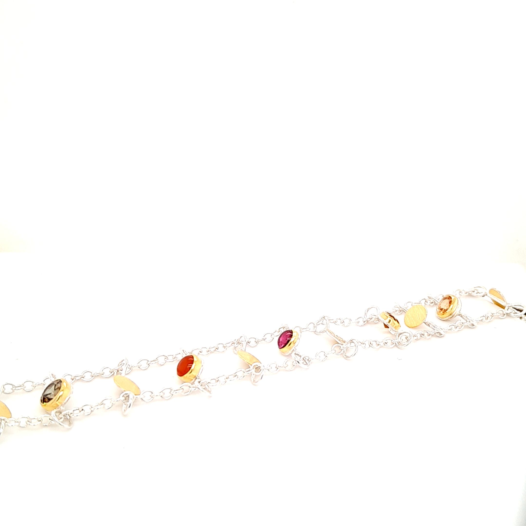 Armband gefertigt in Silber 925 und Gold 900, mit den Edelsteinen: Mandaringranat, Citrin, Turmalin, Karneol, Zirkon und Granat Federring 
Länge 20,3 cm