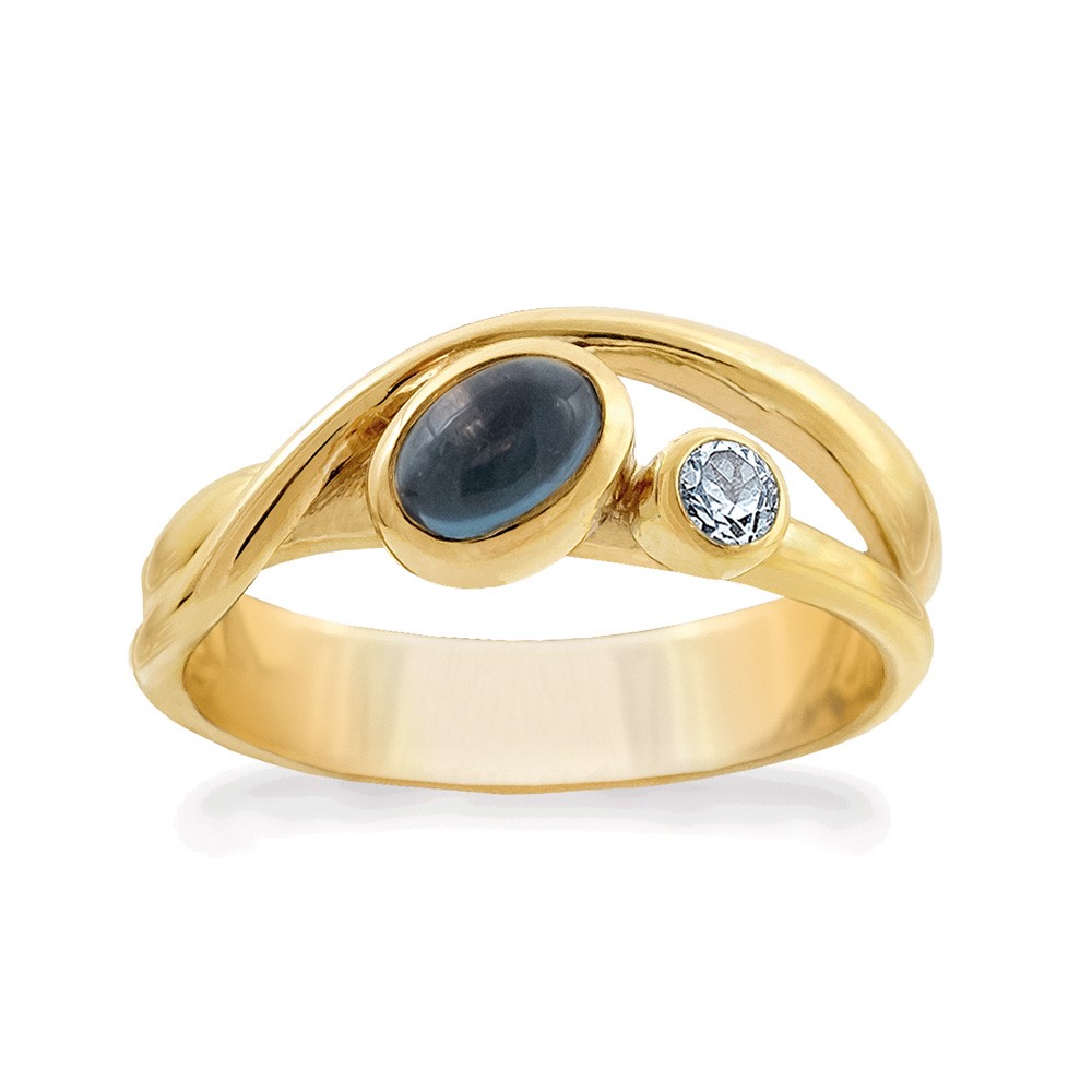 Deze geel goud vergulde ring heeft een 6 x 4 mm London blue topaas en een 3 mm ronde sky blue topaas.