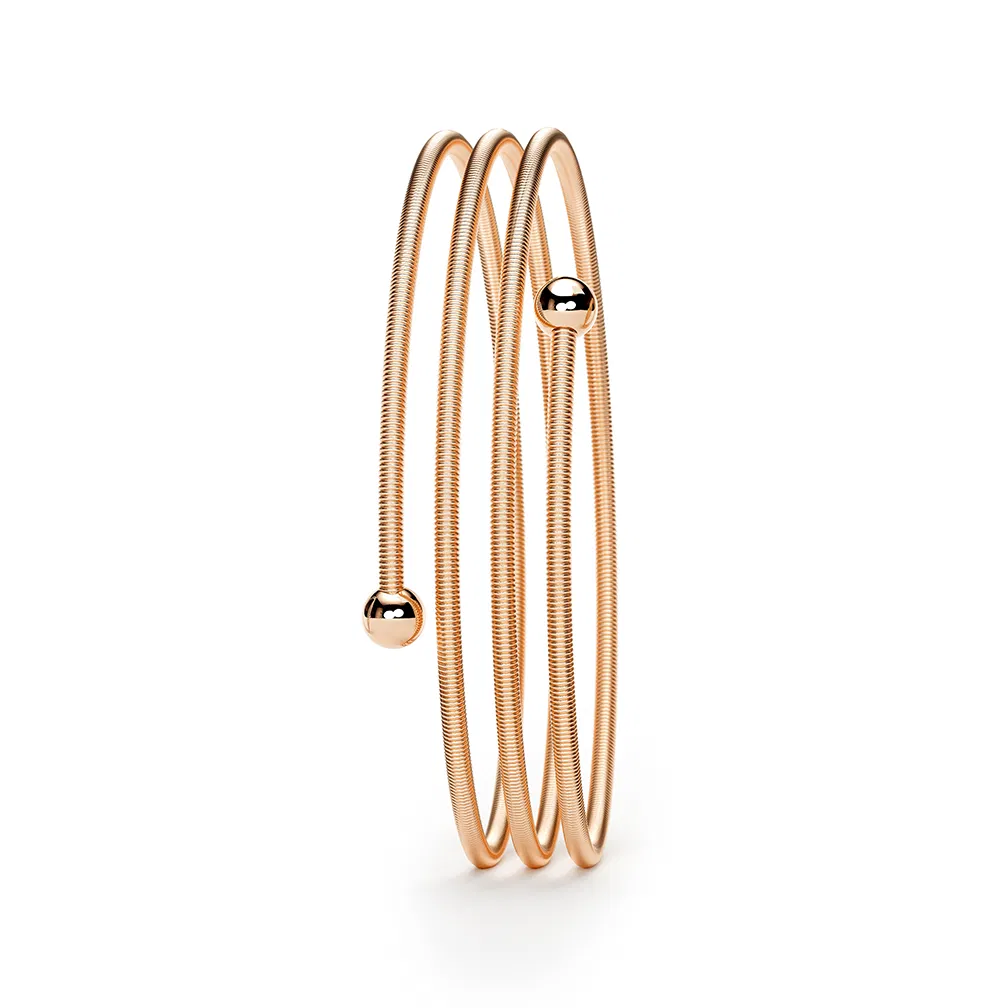 Een 18 krt rosé gouden Niessing armband model Colette C Embrace met 3 wikkelingen. 