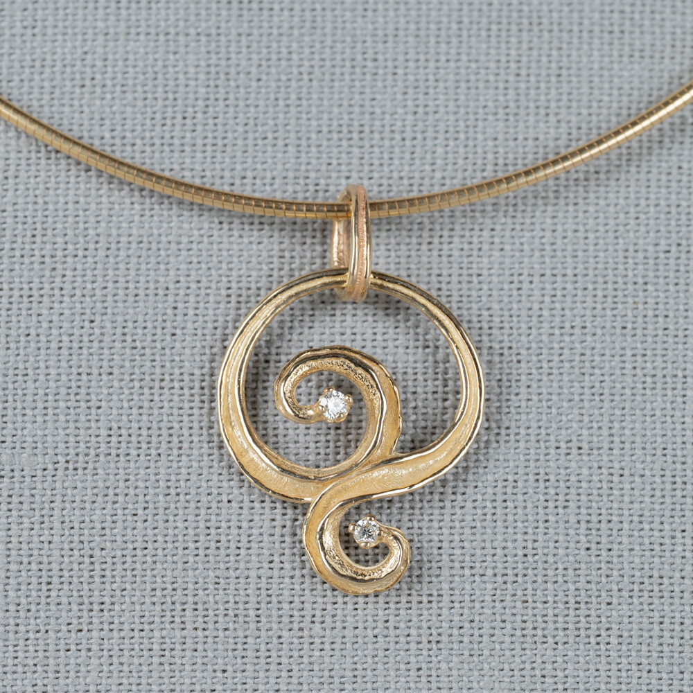 Hanger gemaakt van 14 karaat goud in combinatie met Diamant. Combineer met de andere gouden sieraden uit de Curly-lijn.