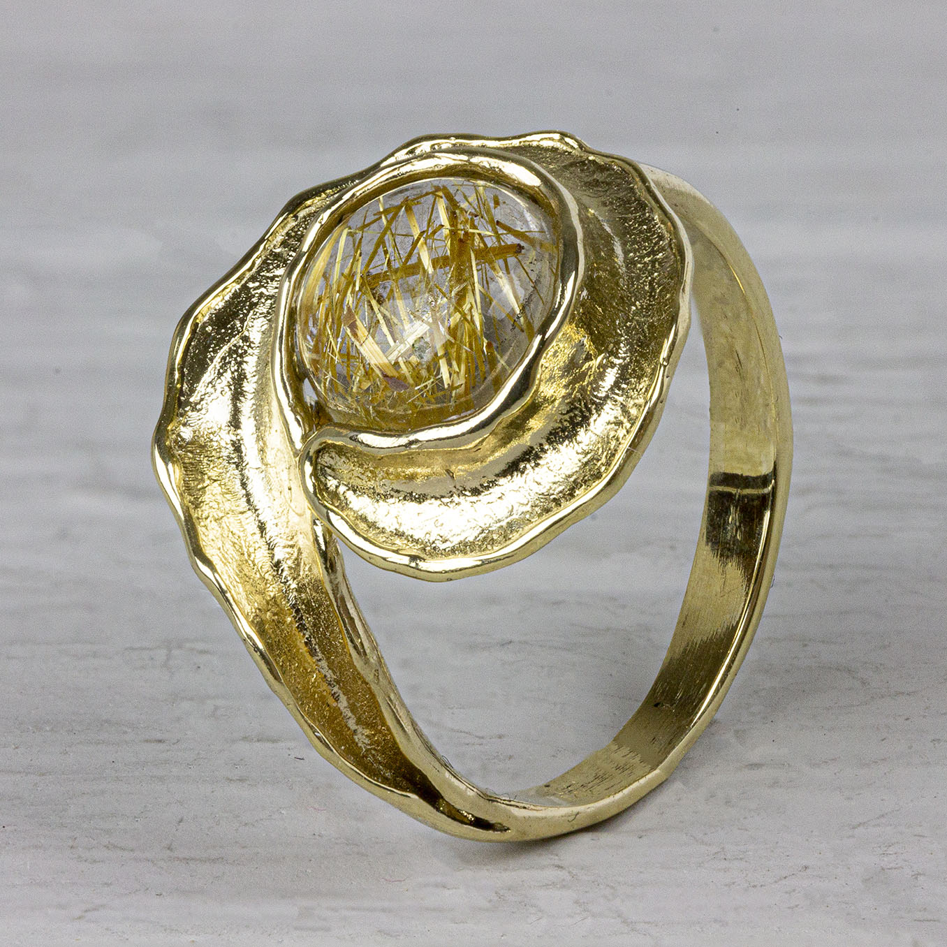 Ring gemaakt van 14 karaat goud met daarin een goude rutielkwarts. De gouden sieradenlijn van Jeh is gemaakt van 14 karaats goud. Dit karaatgehalte wordt in Nederland het meest gebruikt, vanwege de hardheid en de kleur. Puur goud is te zacht om draagbare sieraden van te maken, daarom worden er bij metalen gebruikt. Vaak wordt er zilver en koper gebruikt zodat je kunt blijven spreken van 'edele metalen'. Bij 14 karaat goud zijn er van de 1000 delen, 585 delen puur goud. De overige 415 delen bestaan dus uit de overige metalen. Prijswijzigingen voorbehouden!