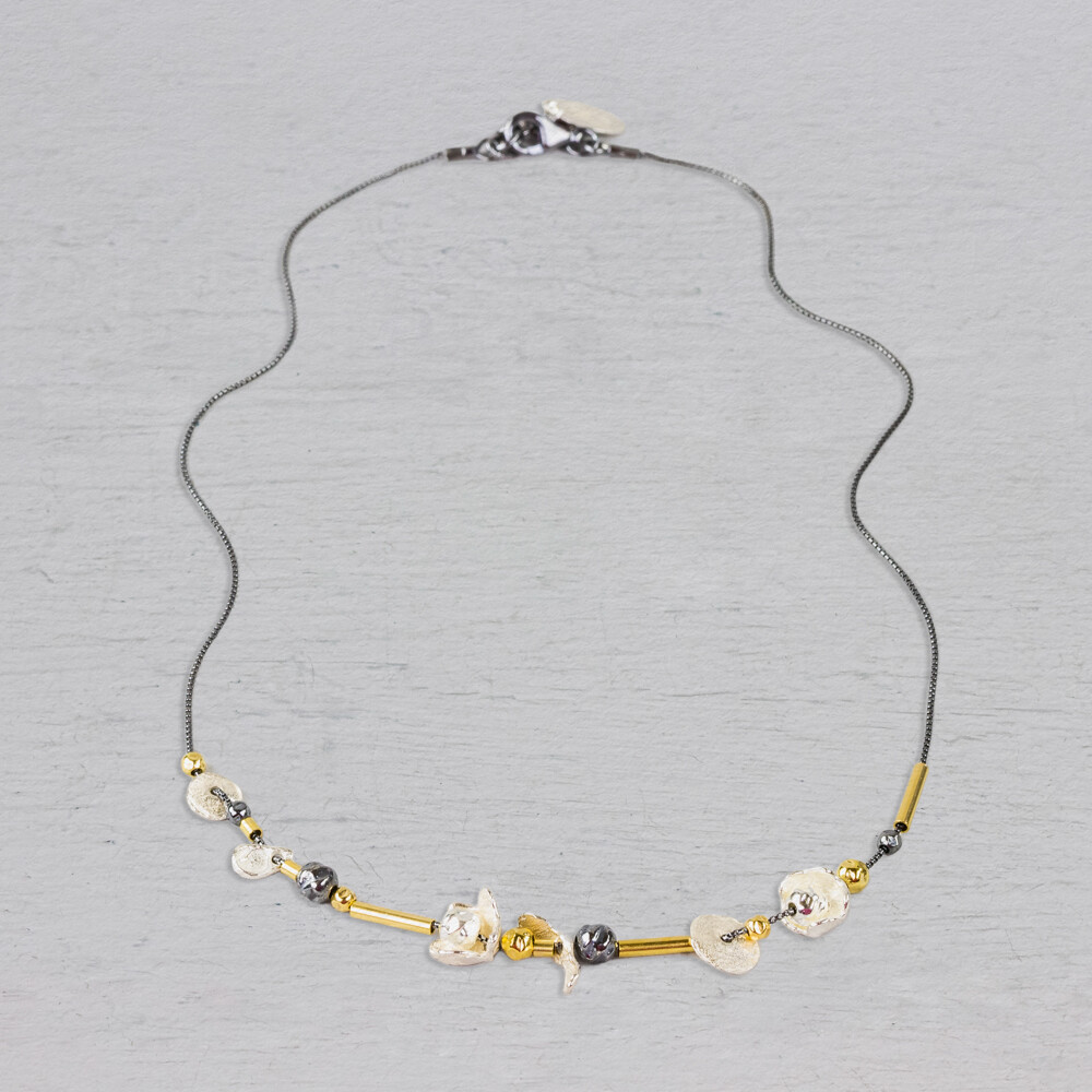 Collier met buisjes, balletjes en bloemetjes. Gemaakt van 925 (geoxideerd) sterling zilver en Goldfilled. Combineer met mooie oorsieraden, een ring en armband. Het collier is verstelbaar waardoor je hem ook op een andere lengte kunt dragen.
