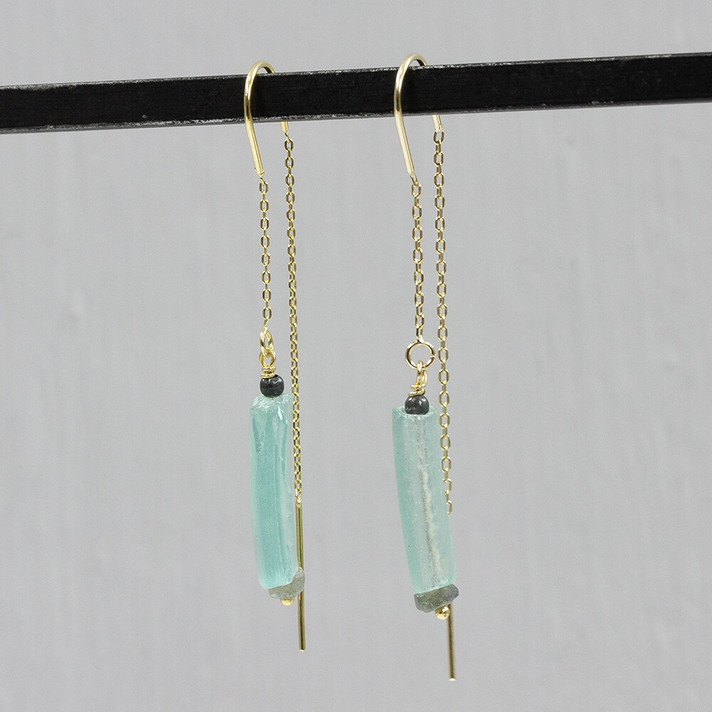Doortrek oorbel zilver verguld met Labradriet en Hematiet en Romeins Glas. Deze oorbel heeft een mooi verhaal. Het is qua uniekheid net een edelsteen, maar deze sieraden zijn gemaakt met Romeins Glas. De romeinen maakten dit 2000 jaar geleden al, met dezelfde reden als wij nu hebben voor glas! De unieke uitstraling en ambachtelijke look paste 32 jaar geleden als perfect in onze collectie. Bij Jeh Jewels zijn wij nog altijd gek op dit eeuwenoude glas en wij hopen jullie nu ook. Roman Glass by Jéh how timeless do you want it to be. De kleur van het Romeinse glas kan iets afwijken van de foto, dit komt doordat alle stukjes uniek zijn.