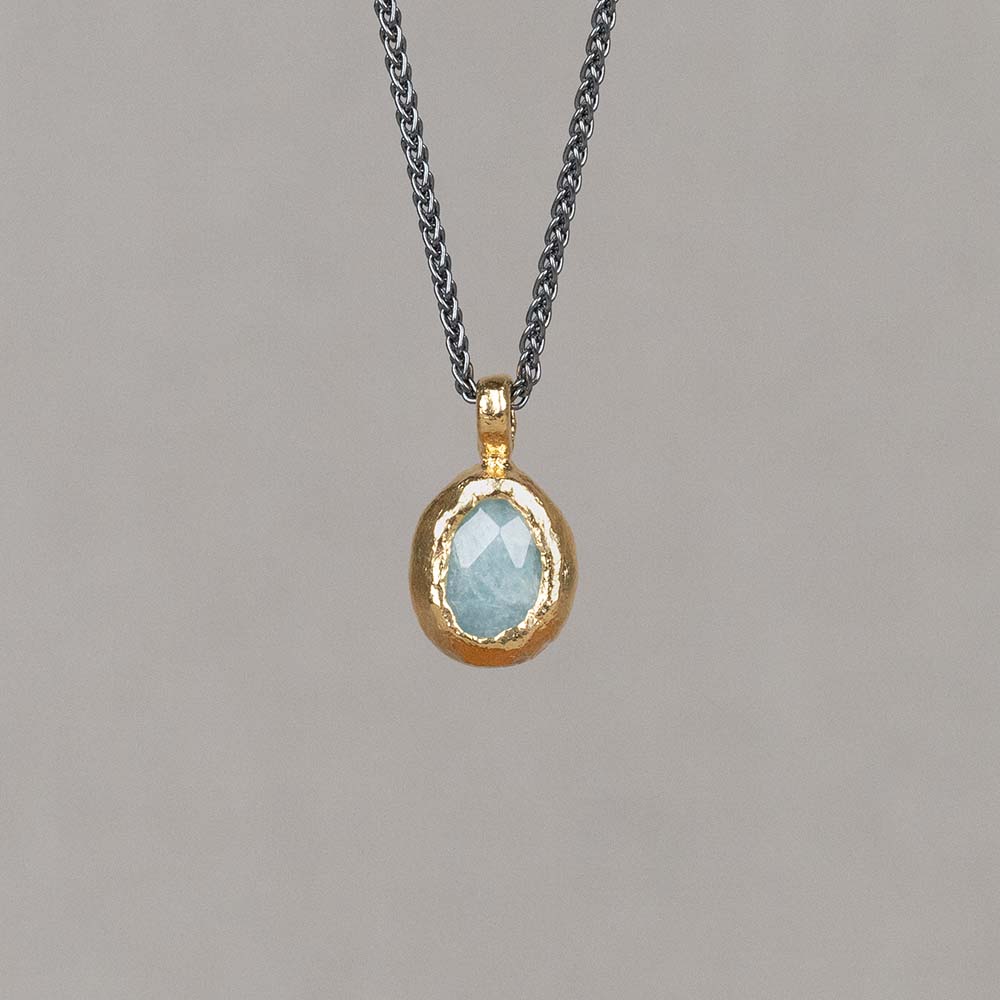 Collier gemaakt van 925 geoxideerd sterling zilver. Aan het collier hangt een gefacetteerde Aquamarijn, omhult met zilver verguld. Aquamarijn is een baken van rust in de storm van het dagelijkse leven. Deze blauwe steen heeft een voedende energie, die je aanmoedigt om jezelf en omstandigheden te accepteren. Draag dit collier met de bijpassende oorhangers voor een complete look!