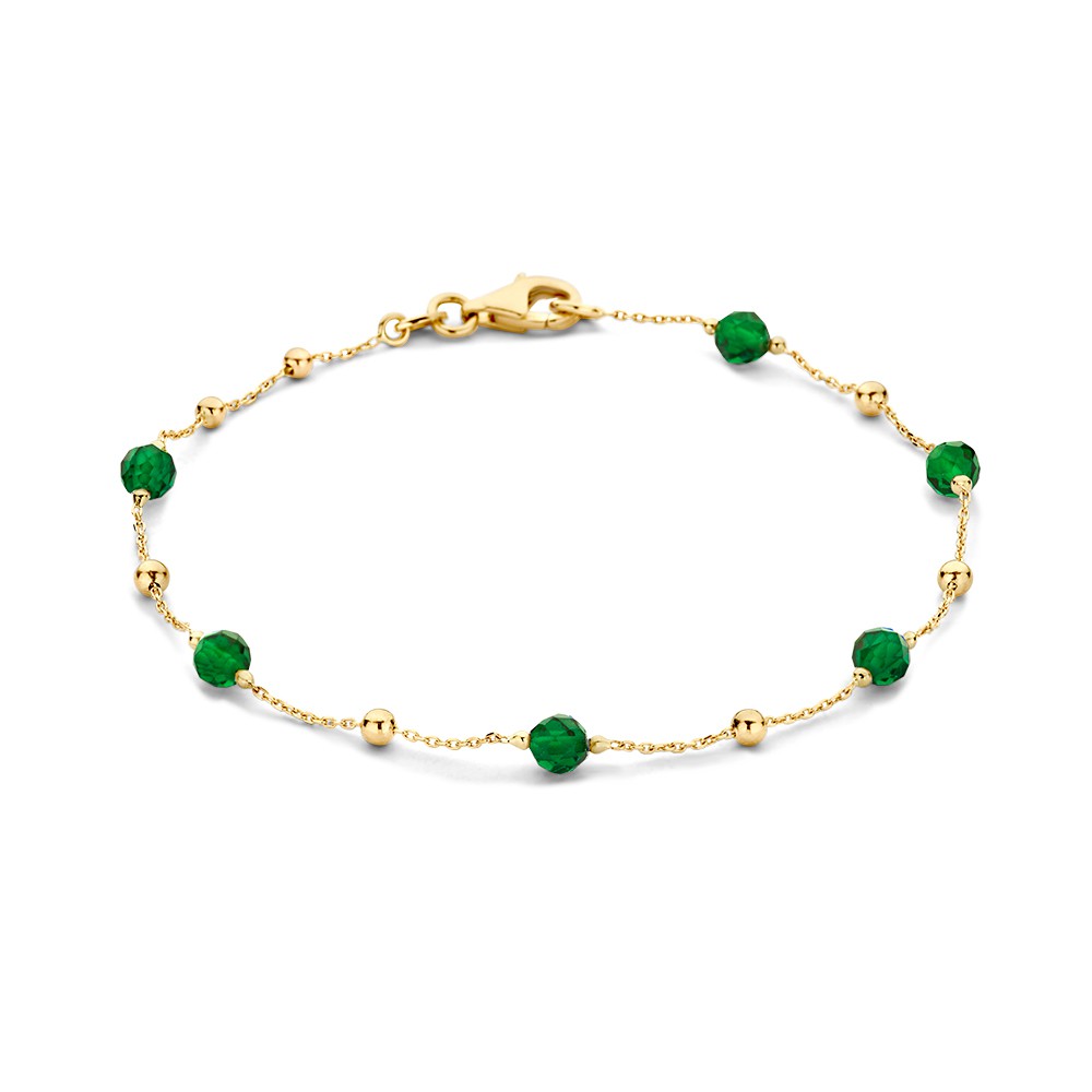 Geelgouden armband met donkergroene zirkonia bolletjes.

