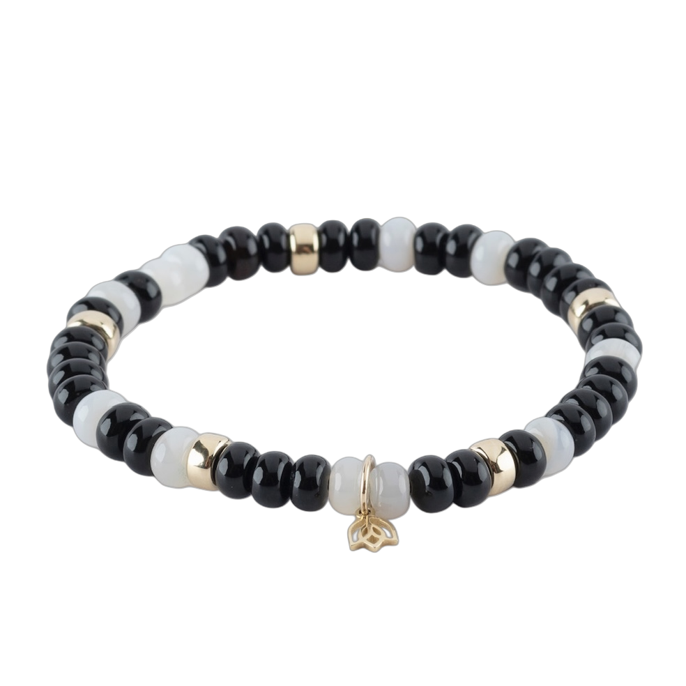 Y&G Edelsteen armband met onyx en agaat
Edelstenen armband (6x4mm kralen) en Vijf 14 krt gouden beads & tulp logo.