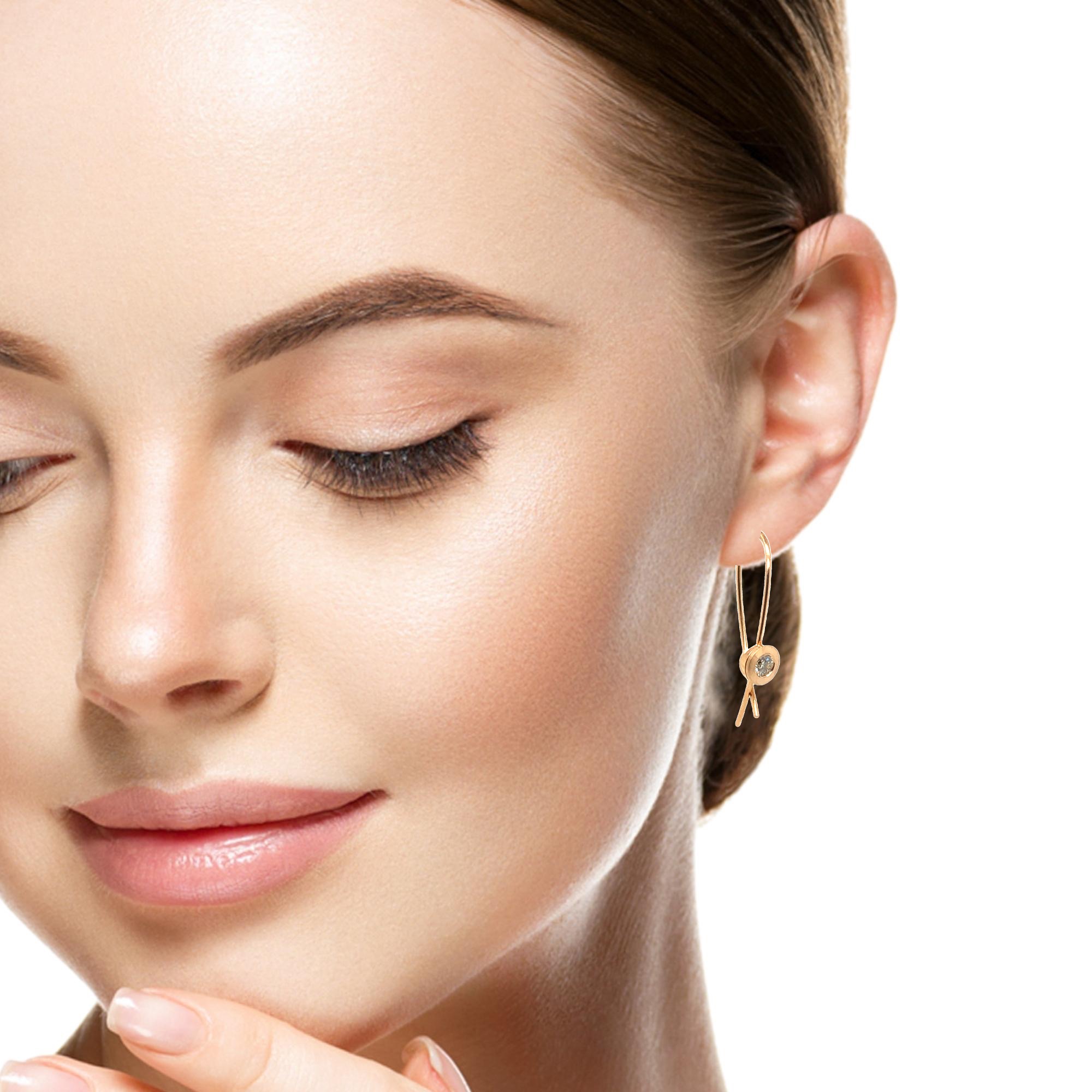 Der Ohrbügel mit je einem Zimtfarbenem Brillanten ist ein eleganter Ohrhänger, der mit hochwertigem Roségold 750 gefertigt wurde. Die gegenläufigen Bügel können, wenn Sie ins Ohrloch eingehängt wurden, gegeninander verschränkt werden, der Ohrschmuck ist damit sicher geschlossen und  vor Verlust geschützt. 
Diese eleganten Ohrhänger sind perfekt für formelle Anlässe und Alltagskleidung. Sie lassen sich am besten tragen, indem sie dezent Ihr Outfit ergänzen und Ihrem Look ein Hauch von Luxus verleihen.