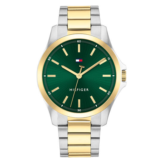 Dit Tommy Hilfiger horloge, uit de Bruce collectie, heeft een bicolor stalen band en kast. De wijzerplaat is groen met goudkleurige indexen en wijzers