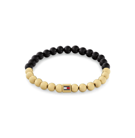 Tommy Hilfiger Jewels TJ2780961 Armband Dames Onix GP 16,5cm
Deze armband van Tommy Hilfiger uit de jewelry serie Semi-Precious met nr: TJ2780961 is een fijn model. De dames armband is in 2 helften verdeeld met kralen. Een helft heeft goudkleurige kralen en de andere helft is Onix. In het midden zit een stalen tonnetje met daarop het Tommy logo. De kralen zijn geregen op elastiek en past om een pols van ong 16,5cm. Ook leuk te combineren met de bijpassende oorbellen en andere sieraden van Tommy Hilfiger.

Het merk:
Tommy Hilfiger is wereldwijd één van de grootste designer lifestyle merken en is internationaal bekend om haar classic American cool stijl. De sieraden zijn voor dames en heren met een eigen stijl, die niet bang zijn om dit aan de wereld te laten zien.

Specificaties:
- Kralenarmband
- Materiaal: Staal GP en Onix
- Lengte 16,5cm op elastiek
- Dames sieraad