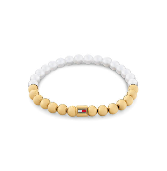 Tommy Hilfiger Jewels TJ2780962 Armband Dames Parel GP 16,5cm
Deze armband van Tommy Hilfiger uit de jewelry serie Semi-Precious met nr: TJ2780962 is een fijn model. De dames armband is in 2 helften verdeeld met kralen. Een helft heeft goudkleurige kralen en de andere helft heeft parels. In het midden zit een stalen tonnetje met daarop het Tommy logo. De kralen zijn geregen op elastiek en is past om een pols van ong 16,5cm. Ook leuk te combineren met de bijpassende oorbellen en andere sieraden van Tommy Hilfiger.

Het merk:
Tommy Hilfiger is wereldwijd één van de grootste designer lifestyle merken en is internationaal bekend om haar classic American cool stijl. De sieraden zijn voor dames en heren met een eigen stijl, die niet bang zijn om dit aan de wereld te laten zien.

Specificaties:
- Kralenarmband
- Materiaal: Staal GP en Parels
- Lengte 16,5cm op elastiek
- Dames sieraad