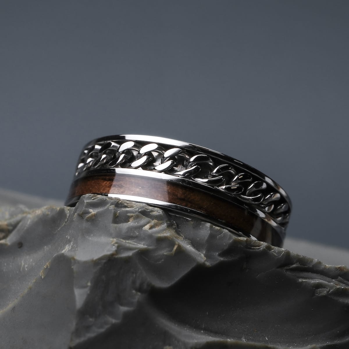 A fractal is a geometric figure in which a small part of the piece behaves in a similar manner to the whole. This means that when the figure is enlarged or reduced, similar structures repeat.

Discover our "Fractional" ring made from walnut wood and stainless steel in silver - inspired by the infinite shapes of fractals. The special coating of the wood makes this unique piece 100% waterproof and should reliably accompany you through those exciting moments of everyday life.