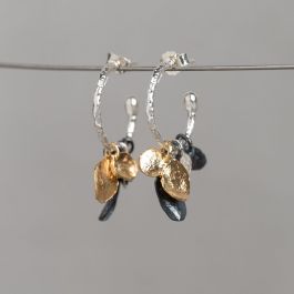 Oorhoepels gemaakt van 925 sterling zilver met daaraan losse hangertjes gemaakt van: 925 sterling zilver, geoxideerd zilver en verguld. Combineer deze oorbellen met het bijpassende collier voor een complete look!