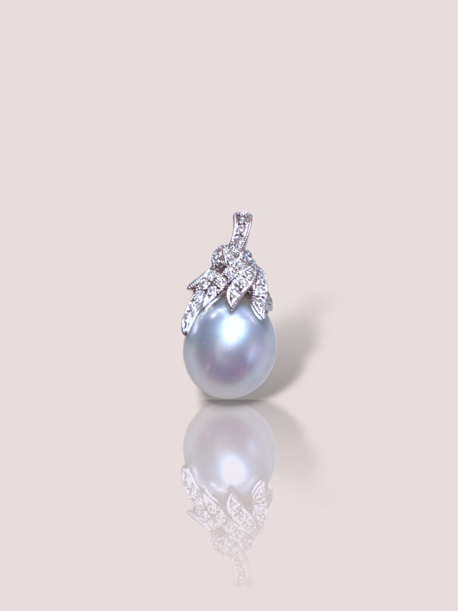 Deze vintage 18k witgouden hanger bevat een grote parel en diamantjes, perfect voor een elegante uitstraling. Draag hem met een fijn ketting voor een subtiele en verfijnde look die past bij elke gelegenheid.

De hanger is van het Duitse juwelenhuis Wempe en bevat een parel van 11,77 mm dikte en 22 briljantjes van in totaal 0,11ct.