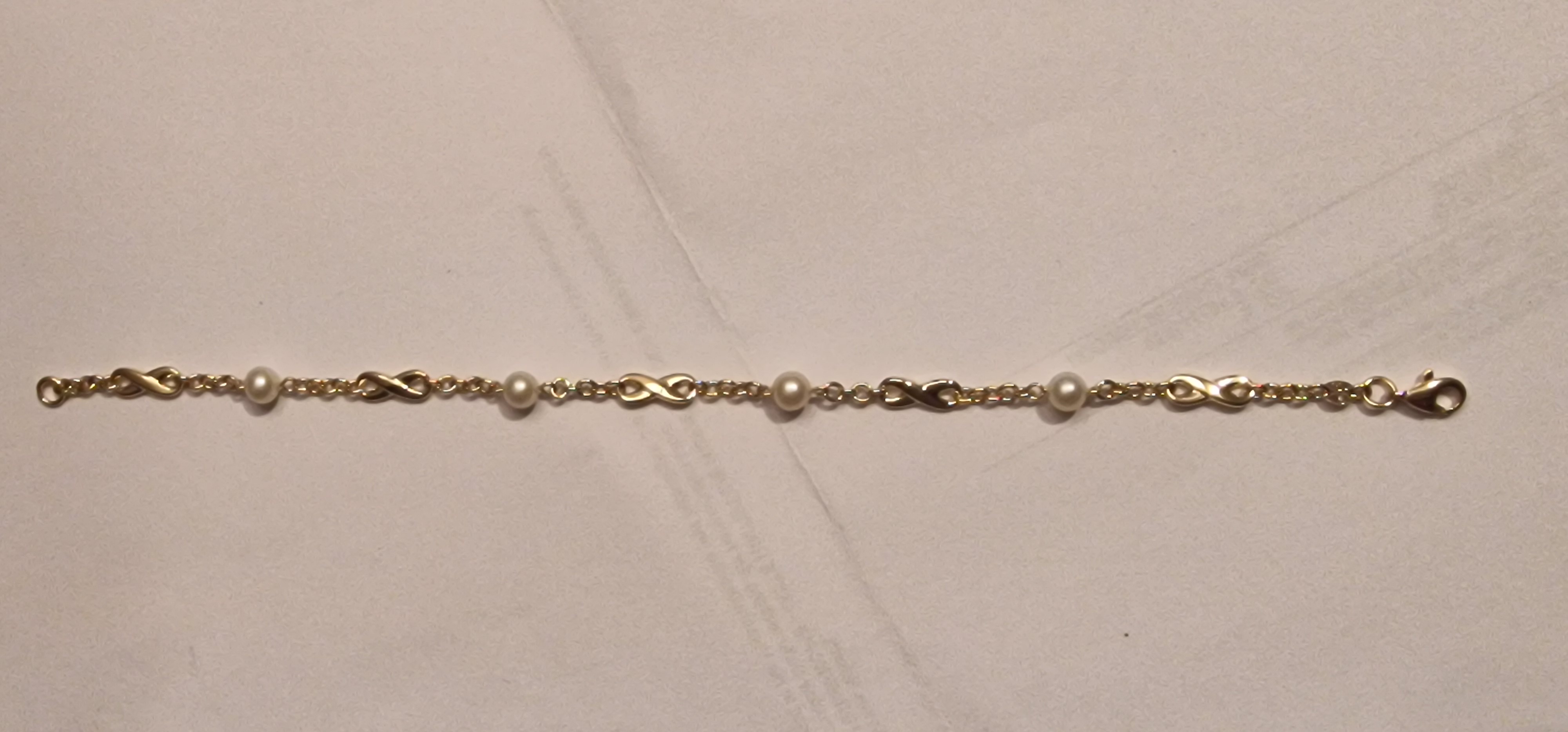 14k geelgouden fantasie schakel armband met infinty teken en 5 mm parels