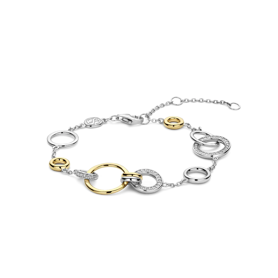 De armband heeft een boeiende ketting met verstrengelde cirkels in verschillende maten. Sommige cirkels schitteren met een luxe laag platina, terwijl andere de warme gloed van geelgoud uitstralen, wat een vleugje moderne weelde toevoegt. Deze verfijnde armband belichaamt de geest van TI SENTO – sieraden die de oneindigheid van het leven verkennen. 