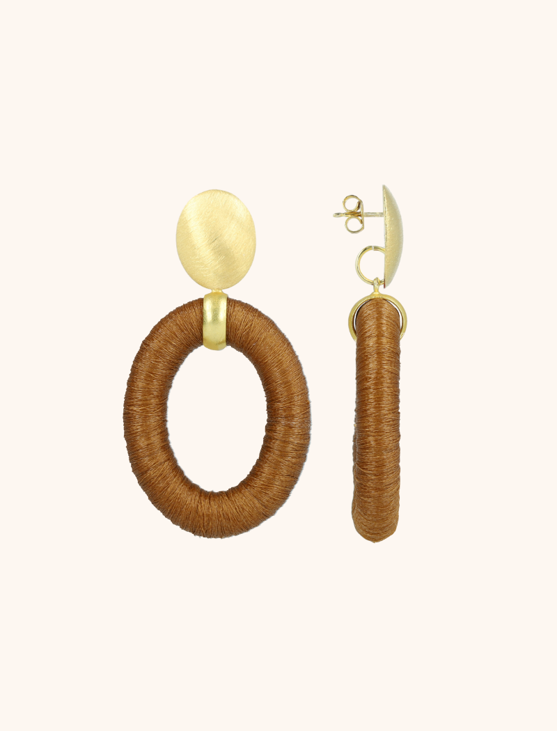 Voeg een vleugje elegantie toe aan je sieradencollectie met de 'Camel Bruine Oorbellen Faye Ovaal Bead Threated L' van LOTT. gioielli. Deze verfijnde oorbellen hebben een ovale vorm en zijn prachtig afgewerkt met kralen en een gedetailleerde draadstructuur in een warme, kameelbruine tint. Ideaal voor zowel formele als informele gelegenheden, deze oorbellen zijn ontworpen om een subtiele maar luxe uitstraling te geven. Dankzij het lichte gewicht zijn ze de hele dag comfortabel te dragen. Draag de 'Camel Bruine Oorbellen Faye Ovaal' en geef je outfit een chique en verfijnde touch. You deserve a LOTT.