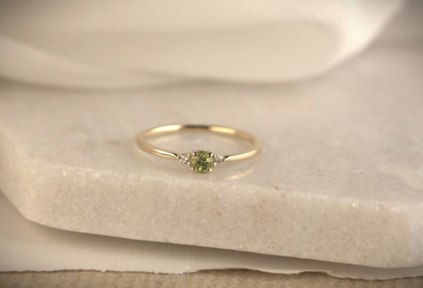 14 Karaat geel gouden dames fantasie ring model Premium MIA.
Mia is een verfijnde ring met 0.03 crt. H/Si briljant geslepen diamanten en een prachtige ronde Peridot.