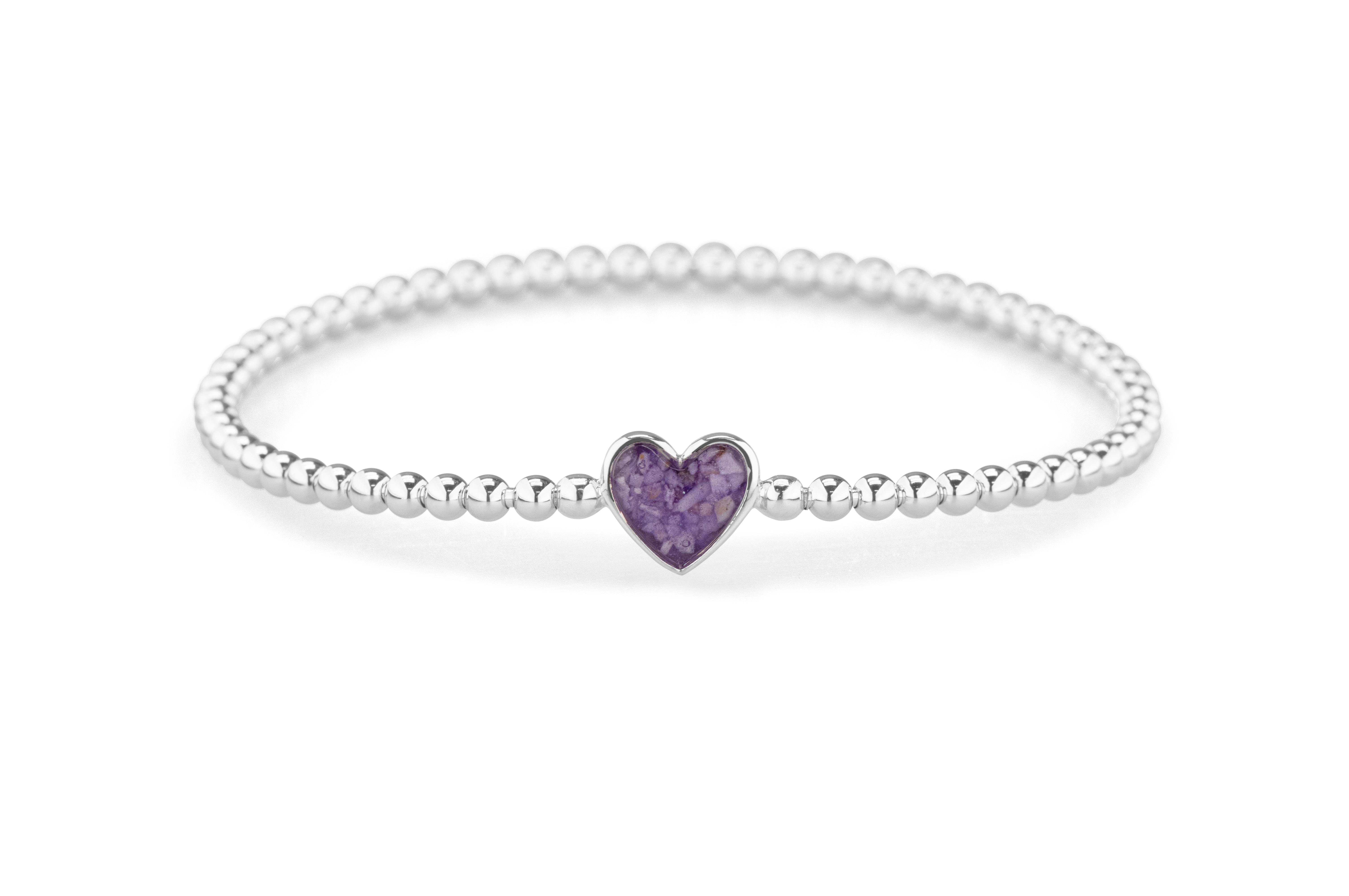 Hart bolletjes armband. Deze flexibele armband is voorzien van een stalen veer (geen elastiek). De armband moet net over de hand kunnen schuiven om mooi aangesloten aan de pols te kunnen dragen. Dit sieraad wordt zichtbaar aan de voorkant gevuld met as of haar en wordt vermengd met onze speciale hars.

verkrijgbaar vanaf €195,-  in zilver 
en €1757,- in 14 krt goud

let op door de fluctuerende goudkoers kunnen de prijzen veranderen.

Leverbaar In  zilver of 14krt geel/wit/of rosé Goud 
en met alle verschillende hars kleuren naar keuze 

U kunt bij ons in de winkel het sieraad samenstellen en zien welke opties allemaal mogelijk zijn