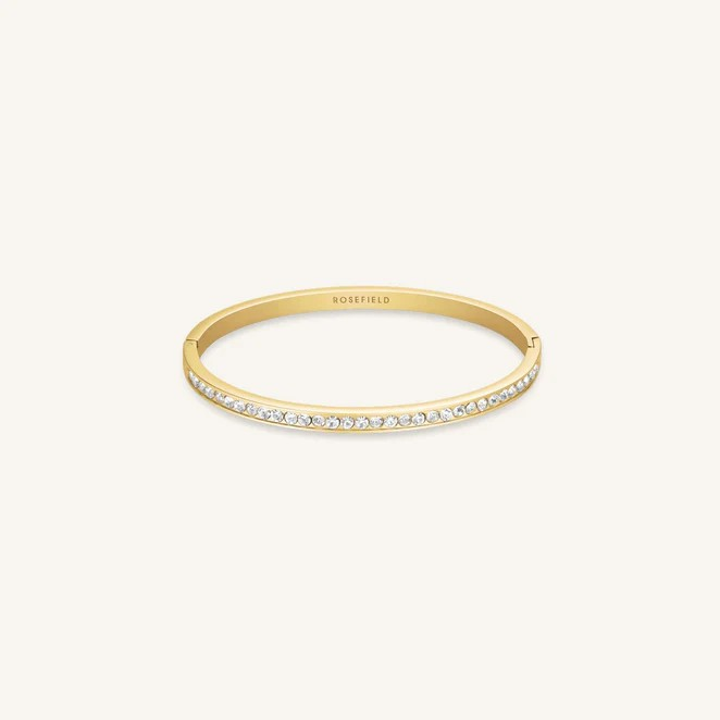 De Rosefield Tennis Bangle JBCBG-J1033 is een verfijnde fantasiearmband van een onbekend merk. Het is perfect als je een moderne en elegante touch aan je outfit wilt toevoegen. Draag deze armband solo voor een subtiele look of combineer met andere armbanden voor een eigen, unieke stijl. Perfect voor elke gelegenheid, van casual tot chic.