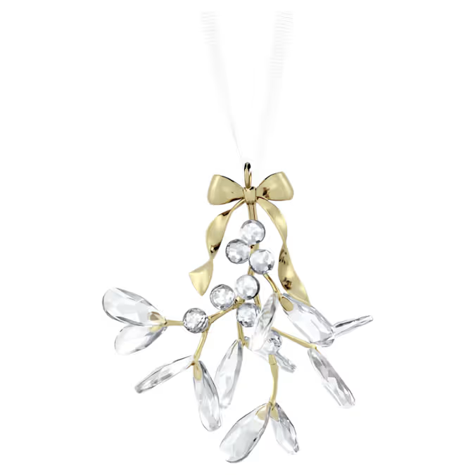 Deze luxueuze ornament is het perfecte excuus om een feestelijke kus te geven. De traditionele maretak hangt aan een wit ripsband lint en is vervaardigd uit glanzend champagnegoudkleurig metaal, met stralende heldere kristallen voor de bladeren en bessen. Met in totaal 1104 facetten zorgt het ontwerp voor eindeloze lichtreflecties in uw feestelijke interieur. Hang het op een prominente plek op om de vreugde van het seizoen te vieren. Decoratieobject. Geen speelgoed. Niet geschikt voor kinderen jonger dan 15 jaar.