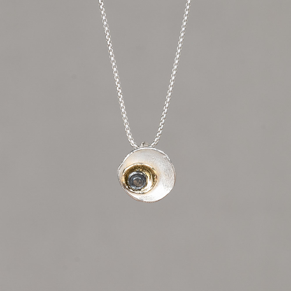 Collier gemaakt van 925 sterling zilver, met daaraan vast een hanger van 925 sterling zilver, geoxideerd zilver en zilver verguld. De hanger bestaat uit 3 verschillende kleuren ronde lagen opgestapeld van groot naar klein. Combineer de hanger met de bijpassende oorstekers.