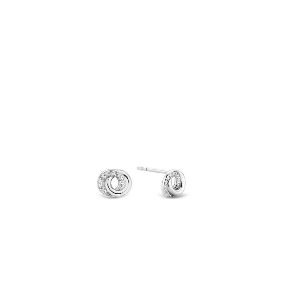 De egale zilveren band en witte zirkonia pave zetting zijn oneindig met elkaar verbonden. Met een glinstering dansen ze op deze elegante oorbellen. Een zilveren schoonheid.