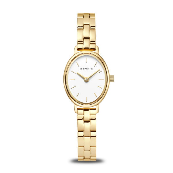 Eleganz, die bleibt – diese BERING Damenuhr aus der Classic-Kollektion verbindet minimalistisches Design mit der feinen Stärke von Titan. 
 Ihr ovales Gehäuse aus goldglänzendem Edelstahl umrahmt das klare weiße Zifferblatt. Schlanke goldfarbene Indizes und Zeiger setzen filigrane Akzente und unterstreichen die nordisch inspirierte Zurückhaltung des Designs. Doch das wahre Highlight offenbart sich beim Tragen: Das fein gearbeitete Gliederarmband aus Edelstahl mit leichten Titanelementen sorgt für einen unvergleichlich angenehmen Tragekomfort – robust, hautfreundlich und dabei kaum spürbar leicht. 
 Ein flaches, kratzfestes Saphirglas schützt das Zifferblatt dauerhaft vor den Spuren des Alltags. Angetrieben wird die Uhr von einem präzisen Quarzwerk, das verlässlich für einen stilvollen Auftritt zur rechten Zeit sorgt. Mit nur 6 mm Gehäusehöhe und einer grazilen Breite von 20 mm wirkt das Modell besonders zart am Handgelenk, während die hochwertige Faltschließe sicheren Halt garantiert. 
 Die Uhr misst 24 mm in der Länge, das Armband ist 180 mm lang und 8 mm breit. Sie ist bis zu 3 ATM wasserdicht – perfekt für den Alltag mit Stil. 