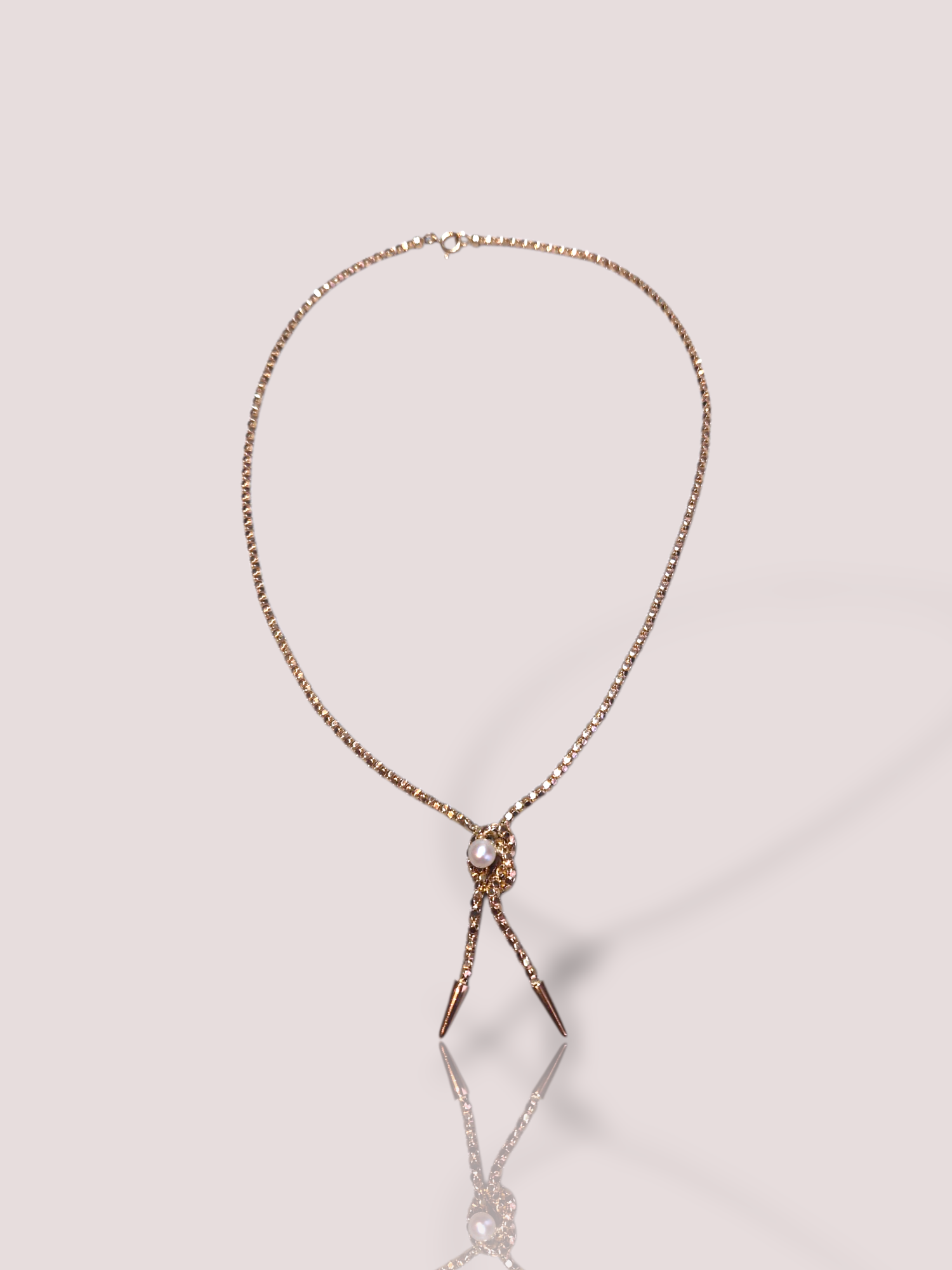 Dit vintage 18k rosé gouden fantasie collier is een verfijnde ketting met een prachtige parel, een sieraad in de categorie halskettingen. Dit collier past perfect bij zowel formele als casual outfits en voegt een vleugje elegantie toe aan elke look. Draag het met een eenvoudige jurk voor een chique uitstraling. 

Het collier heeft een prachtige 'knoop' welke is afgewerkt met een zoetwaterparel.