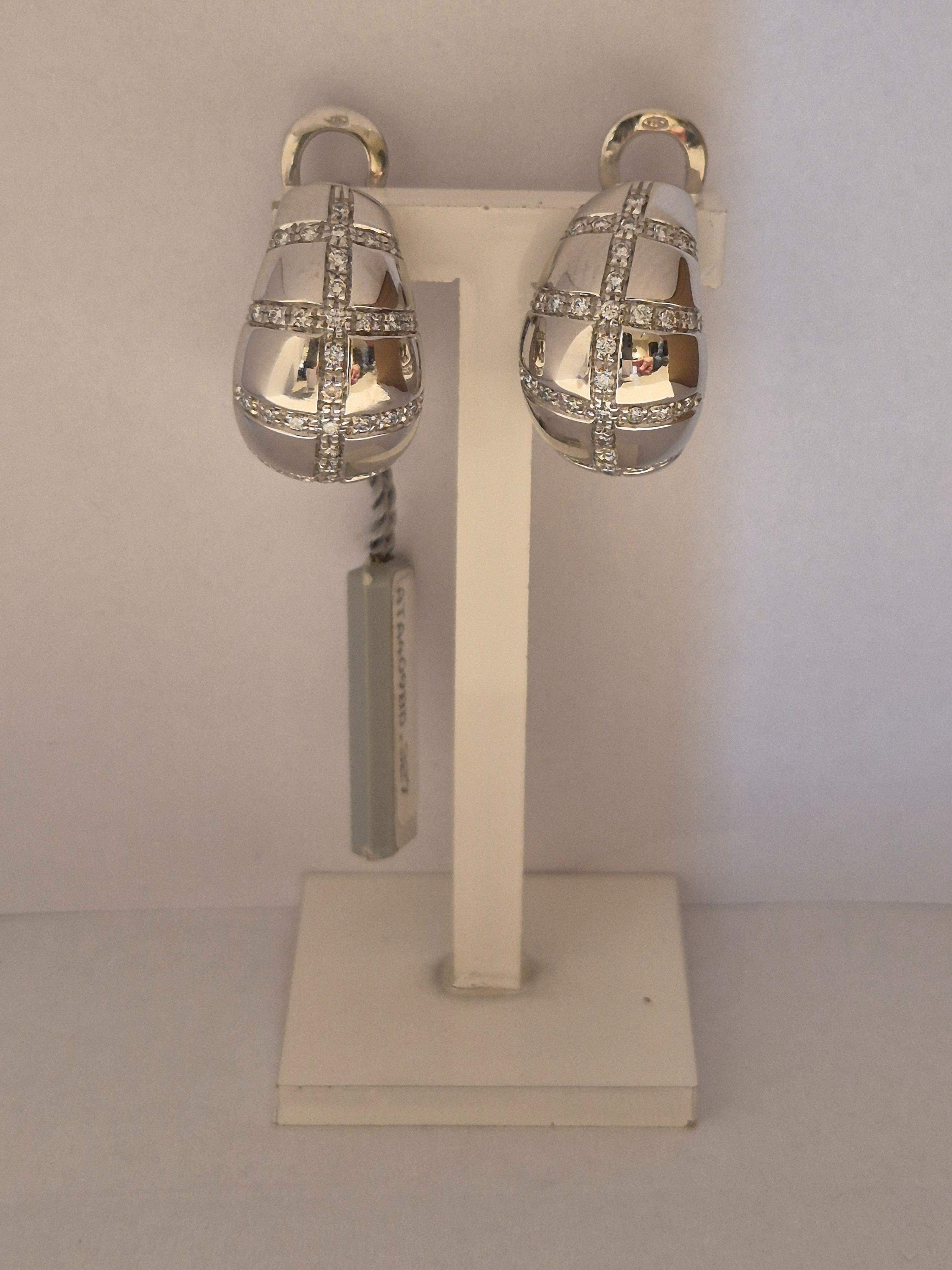 De 18krt. witgouden oorbellen met diamant (0.58ct), modelnummer zijn prachtige oorbellen van 18-karaats goud, en voorzien van een klapsluiting voor extra veiligheid. Ook te dragen als clip oorbel. De oorbellen stralen verfijnde elegantie uit en zijn perfect voor dagelijks gebruik of speciale gelegenheden. Draag ze met opgestoken haar voor een stijlvolle en verfijnde look.