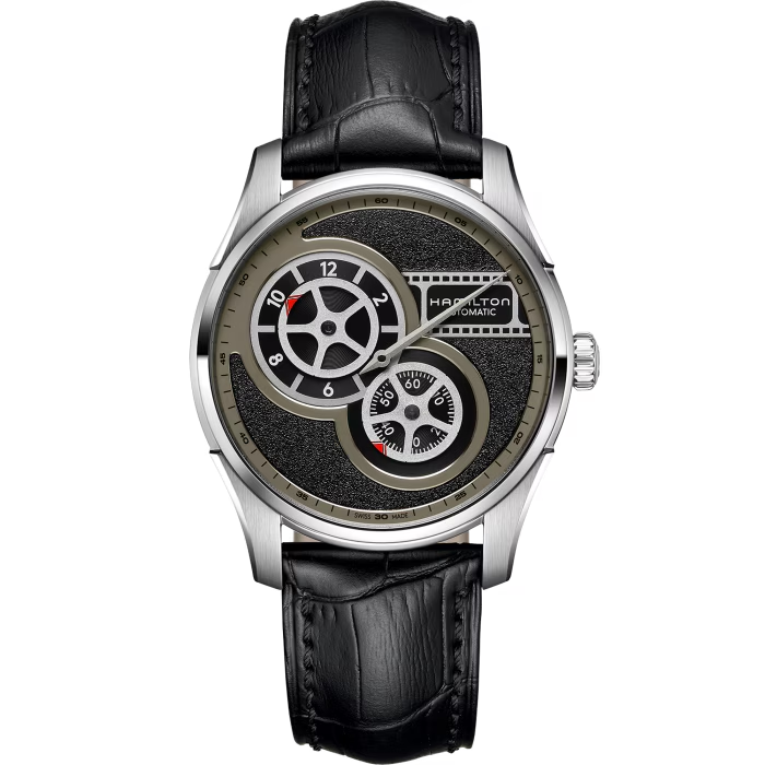 De Hamilton Jazzmaster Regulator Cinema 42mm, modelnummer H42605731, beschikt over een automatische Zwitserse beweging, saffierglas en een roestvrijstalen kast. Met een waterdichtheid van 50 meter en een zwarte leren band is deze horloge zowel stijlvol als functioneel. Perfect voor dagelijks gebruik of speciale gelegenheden. Draag hem om uw pols voor een verfijnde en elegante look.