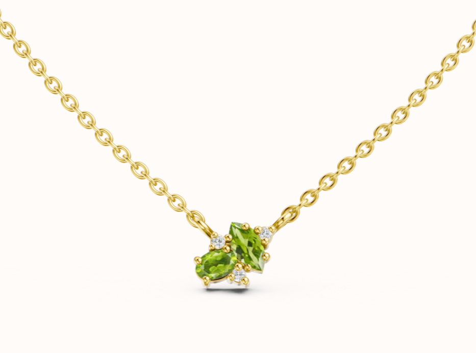 Softly shimmering and effortlessly refined, this fine chain necklace features a delicate cluster of 2x oval peridot gemstones accented with scattered white diamonds. Inspired by the lush greens of a peacock&rsquo;s plumage, it&rsquo;s the perfect piece to wear solo or layered for a modern, romantic touch. Crafted with meticulous attention to detail in 925 sterling silver.