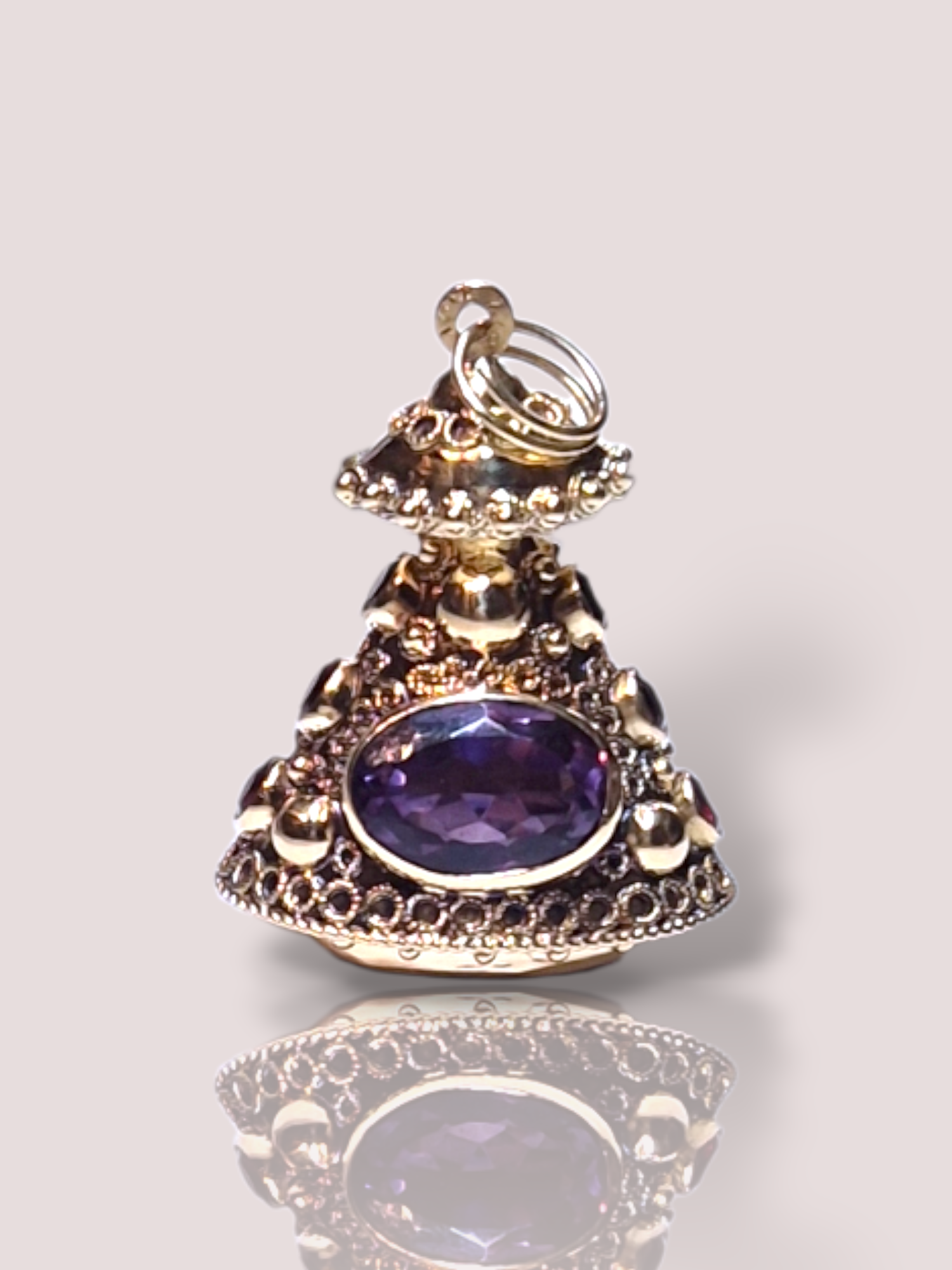 Deze vintage 18k geelgouden hanger, combineert de schittering van amethist met de diepe tinten van granaat. Perfect als sieraad aan een dikkere lange ketting. Draag het aan een fijne ketting voor een elegante look, ideaal voor zowel dagelijkse elegantie als speciale gelegenheden.

De hanger is met 4 cm lang een echte statement en zeer uniek!