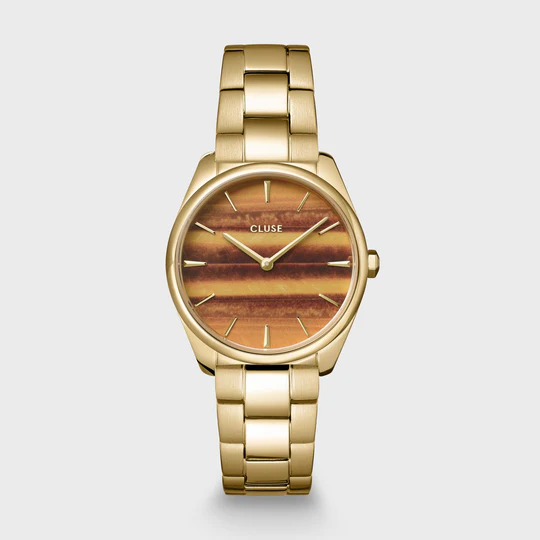 Het ronde F&eacute;roce Petite horloge voor dames heeft een goudkleurige kast van 31.5 mm, een oranje wijzerplaat van tijgeroog en een 16 mm goudkleurig 3-schakelbandje van roestvrij staal.