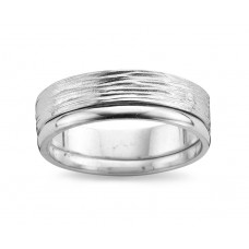 De trouwring is in witgoud 18 kt . De ring is gehamerd met onderaan een gepolijste lijn. De ring is 6 mm breed.