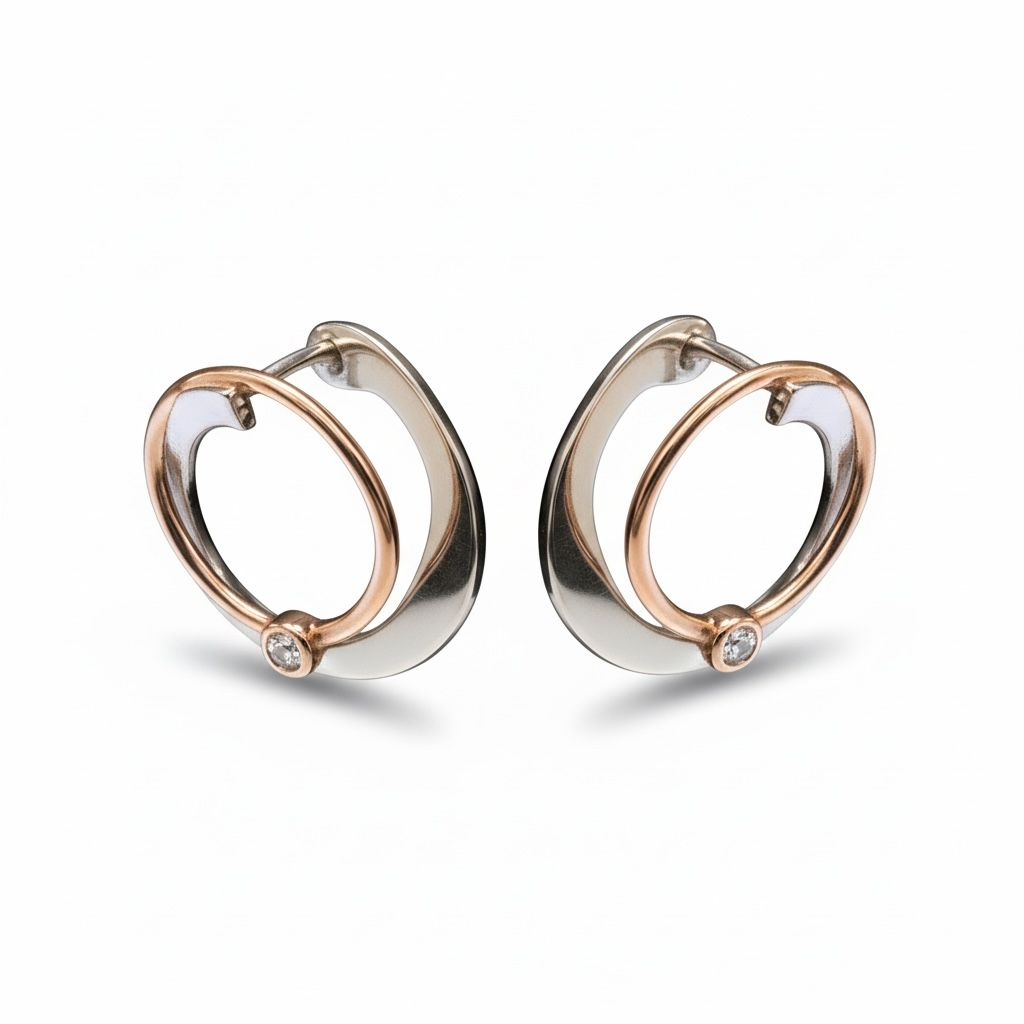 Zilver vergulde creolen met ros&eacute; en zirkonia.