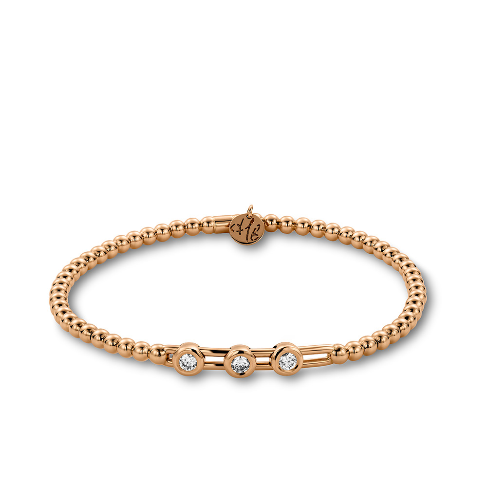 Een verfijnd juweel in 18-karaat ros&eacute;goud met een elegante combinatie van goudbolletjes en sprankelende diamanten. Het flexibele stretchdesign zorgt voor een perfecte pasvorm en maakt de armband zowel stijlvol als comfortabel om dagelijks te dragen.