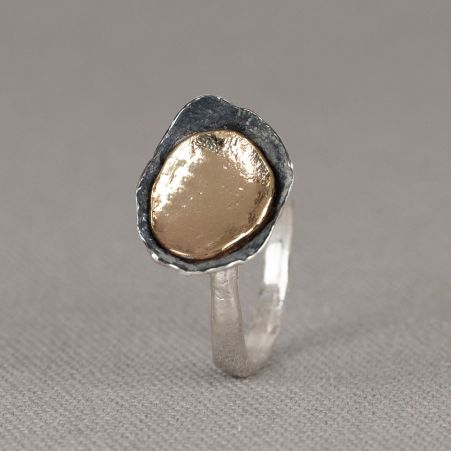 Ring gemaakt van 925 sterling zilver met daarop een schaaltje van geoxideerd zilver en 9 karaat. Draag deze ring in combinatie met de bijpassende oorbellen en het bijpassende collier voor een complete look!
