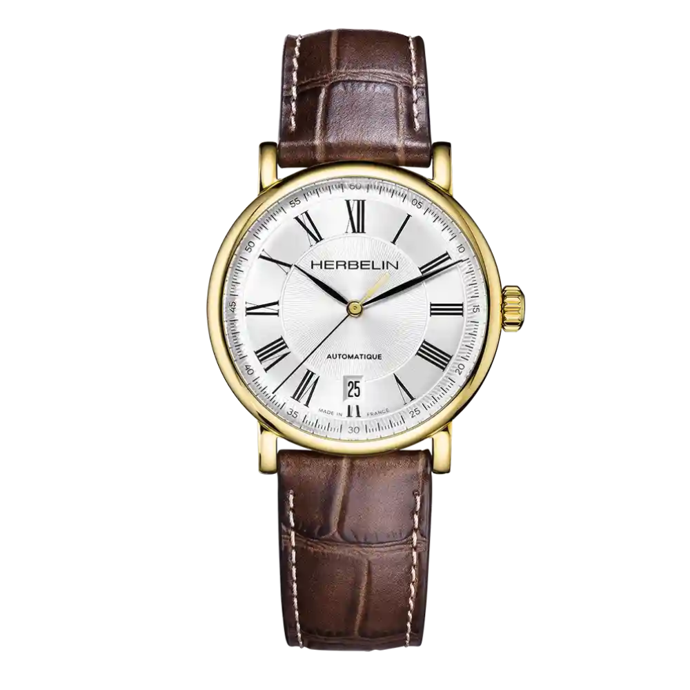 De Herbelin Inspiration Automatique is een klassiek herenhorloge met goudkleurige kast, zilveren wijzerplaat en bruine leren band. Voorzien van een automatisch Zwitsers uurwerk en saffierglas voor een elegante en betrouwbare uitstraling.