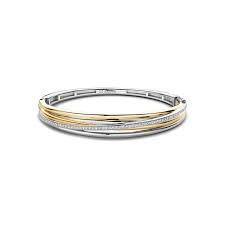 De TI SENTO Bracelet Gilded, modelnummer 23046ZY, is een verfijnd sieraad gemaakt van zilver met een gewicht van 31,53 gram. De armband is goud- en zilverkleurig, wat voor een elegante uitstraling zorgt. Draag deze armband als een statement stuk of combineer met andere sieraden voor een gelaagde look. Perfect voor elke gelegenheid!