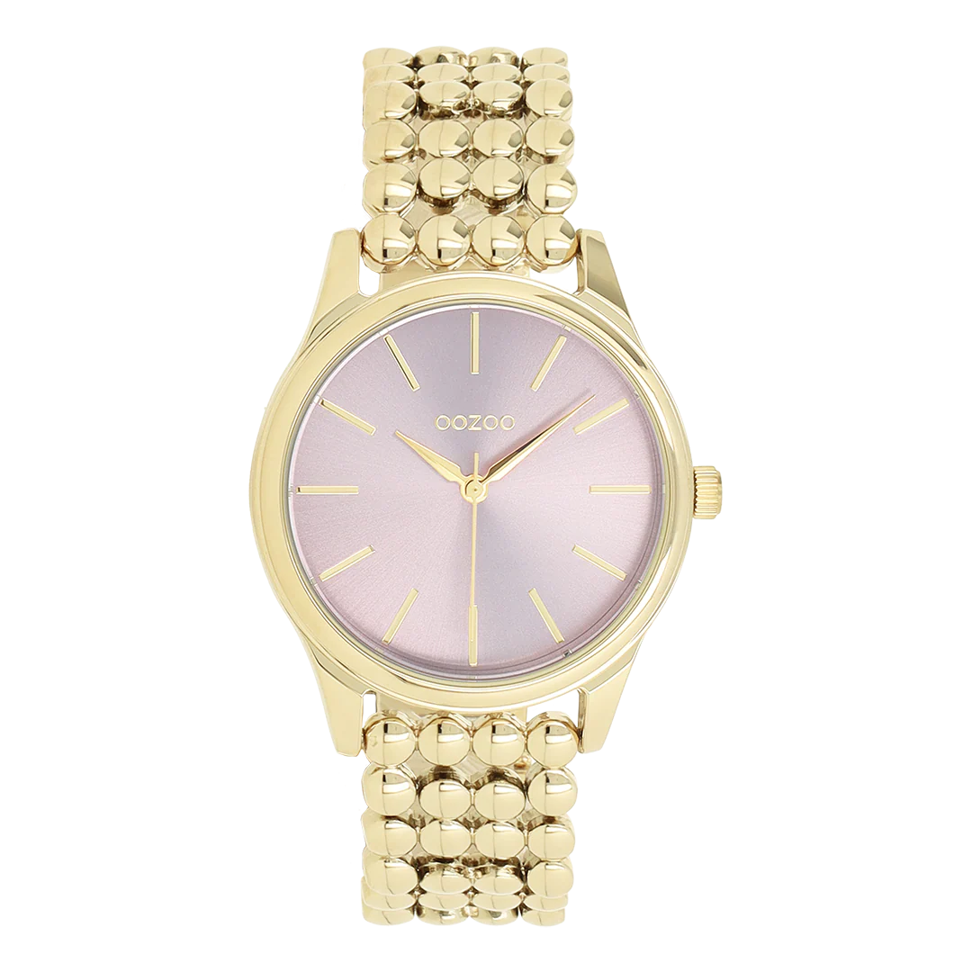 Val op met dit prachtige ronde dameshorloge uit de trendy OOZOO Timepieces collectie. De C11672 heeft een goudkleurige schakelarmband en een goudkleurige metalen horlogekast van 36 mm. Met de roze wijzerplaat met zonnestraalmotief, de goudkleurige cijferstrepen en de bijpassende wijzers maak je een stijlvol statement. Dit onmisbare horloge voor je garderobe heeft mineraalglas, een roestvrijstalen achterkant en is nikkelbestendig. Het horloge is voorzien van een Japans uurwerk met een waterdichtheid van 2 ATM