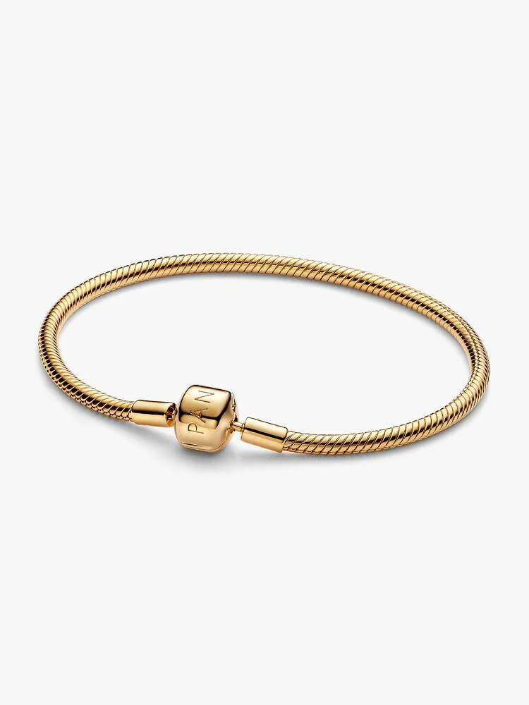 Style meer van de bedels waar je van houdt met onze vergulde snake chain-armband met cilindersluiting. De cilindersluiting maakt al lang deel uit van het erfgoed van Pandora en was een van onze allereerste snake chain-armbandontwerpen. Hier krijgt de sluiting een moderne update met strakkere details. Vier de geschiedenis van Pandora met dit iconische stuk en maak hem vast onderdeel van je collectie