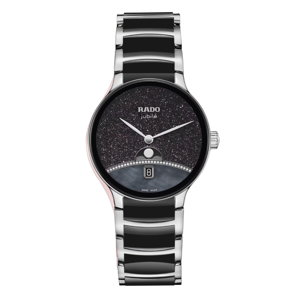 De Rado Centrix Moonphase Limited Edition is een exclusief Zwitsers dameshorloge waarin elegantie en vakmanschap samenkomen. De bijzondere wijzerplaat met parelmoer, aventurijn en 29 diamanten cre&euml;ert een schitterende sterrenhemel rond de maanfase-indicatie. De combinatie van roestvrij staal, zwarte high-tech keramiek en krasbestendig saffierglas zorgt voor een luxueuze uitstraling en optimaal draagcomfort. Aangedreven door een betrouwbaar Zwitsers quartzuurwerk en wereldwijd gelimiteerd tot slechts 1.001 exemplaren is dit een uniek verzamelobject voor liefhebbers van exclusieve horloges.