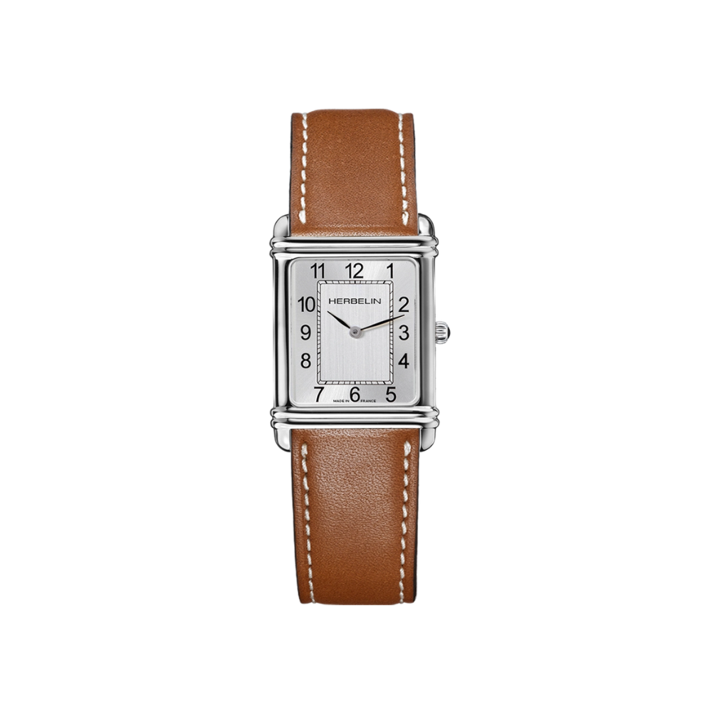 Herbelin Art D&eacute;co is een stijlvol herenhorloge met een karakteristieke rechthoekige roestvrijstalen kast, een verticaal geborstelde zilverkleurige wijzerplaat en een luxe bruine leren band. Het betrouwbare Zwitserse quartz uurwerk, krasbestendig saffierglas en het iconische Art D&eacute;co-design maken dit horloge tot een tijdloze keuze voor iedere gelegenheid.