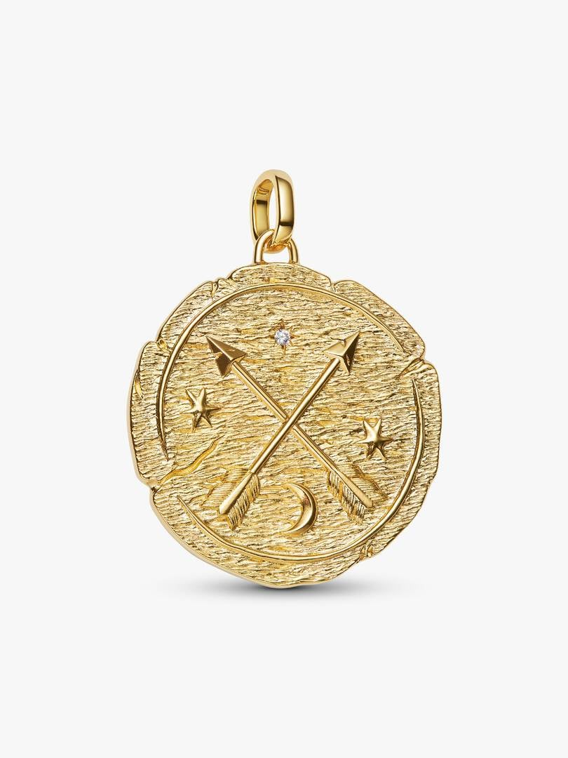 Een herinnering dat het beste nog moet komen. Dit met goud vergulde XL-medaillon heeft gekruiste pijlen in combinatie met de Latijnse inscriptie 'AD MELIORA' - 'OP NAAR IETS BETERS'. Een uitnodiging om de woorden te dragen waar je naar leeft.