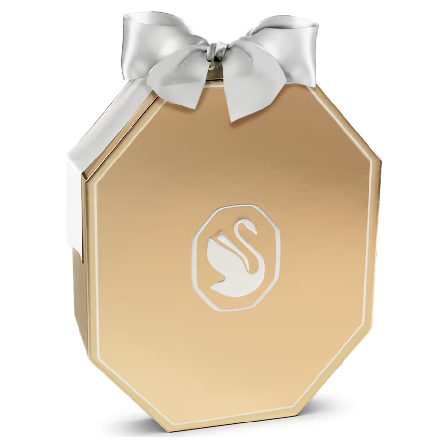 De geliefde adventskalender van Swarovski is terug in 2026 met 25 nieuwe deurtjes. Achter elk deurtje vindt u een uniek kristallen ornament voor uw kerstdecoratie, van sterren, sneeuwvlokken en manen tot klokjes, kerstballen, de geliefde Beer Kris en vier adventskaarsen die u op een standaard kunt plaatsen. Samen met de witte ripsband linten komt de hele set tot leven door de verschillende Swarovski-kristaleffecten, zodat u het seizoen kunt vieren met een schittering vol licht. Open ze dit jaar en koester ze voor altijd binnen uw familie. Decoratief voorwerp. Geen speelgoed. Niet geschikt voor kinderen jonger dan 15 jaar.

Artikelnr.: 5732493
Collectie:  Annual Edition
Formaat: 41.5 x 10.6 x 33.2 cm
Materiaal:  Kristallen, Polyester, Metaal met champagnegoudkleurige afwerking, Glas
Kleur:  Wit