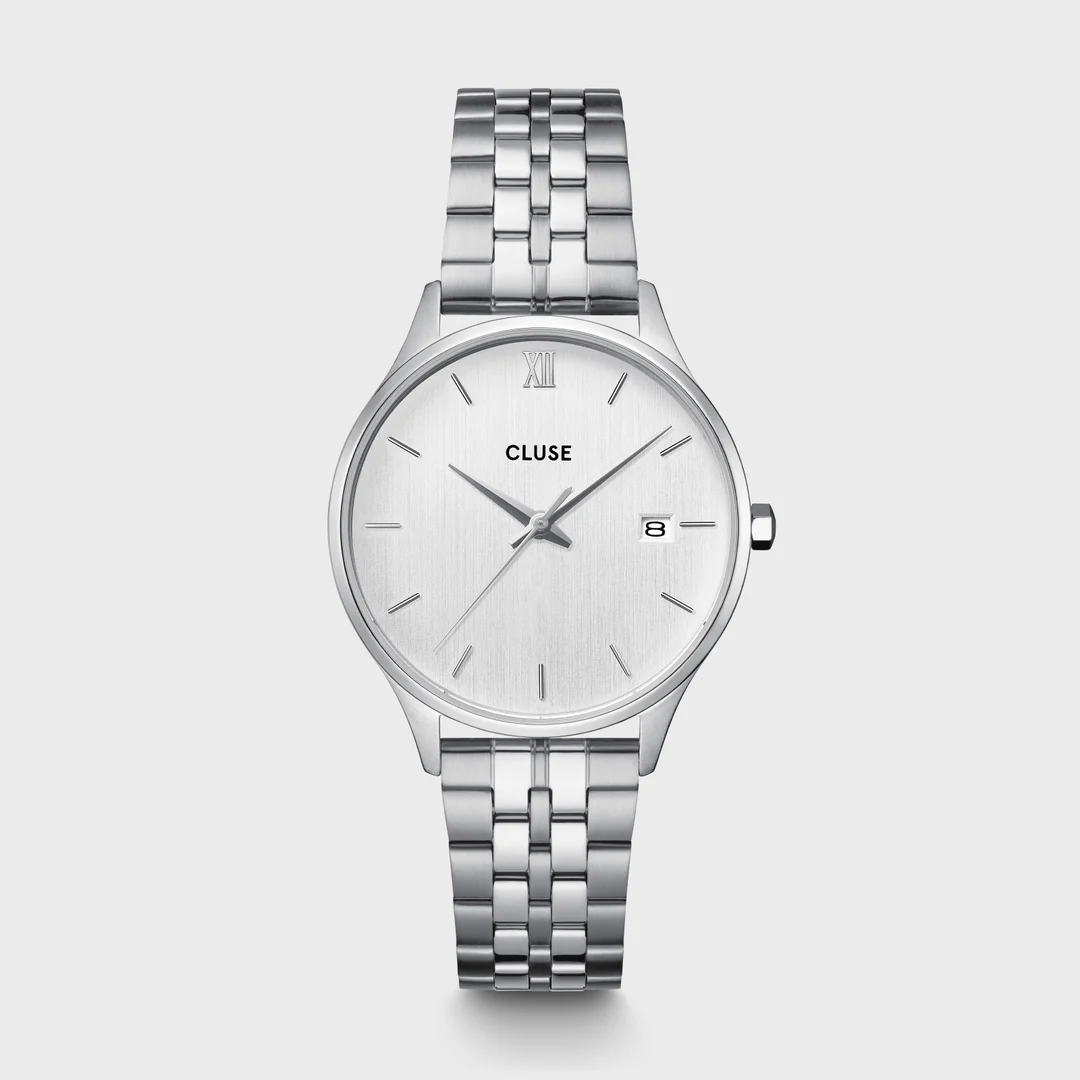 Het ronde Minuit Date horloge voor dames heeft een 34 mm zilverkleurige kast, zilverkleurige wijzerplaat en een 16 mm zilverkleurig 5-schakelbandje van roestvrij staal.
