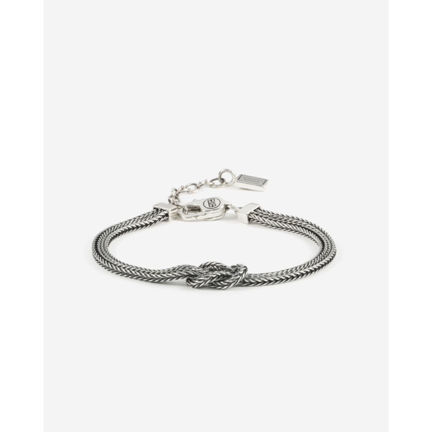 De Bracelet Barbara Mini Knot Zilver (1.8mm) is een subtiele maar stoere armband die staat voor liefde, kracht en verbondenheid. Het verfijnde gevlochten ontwerp in 925 zilver is tijdloos en veelzijdig. Ontworpen in Amsterdam en met de hand gemaakt door vakmensen in Zuidoost-Azi&euml;, draag je met deze armband een stukje authentiek vakmanschap. Perfekt als symbool van jullie band of als cadeau dat een blijvende indruk achterlaat. Solo gedragen straalt hij elegantie en kracht uit, maar gecombineerd met bijvoorbeeld de Katja XS of Ben Small armband ontstaat een stoere layered look. De Barbara Mini Knotted is karaktervol en 100% Buddha to Buddha.