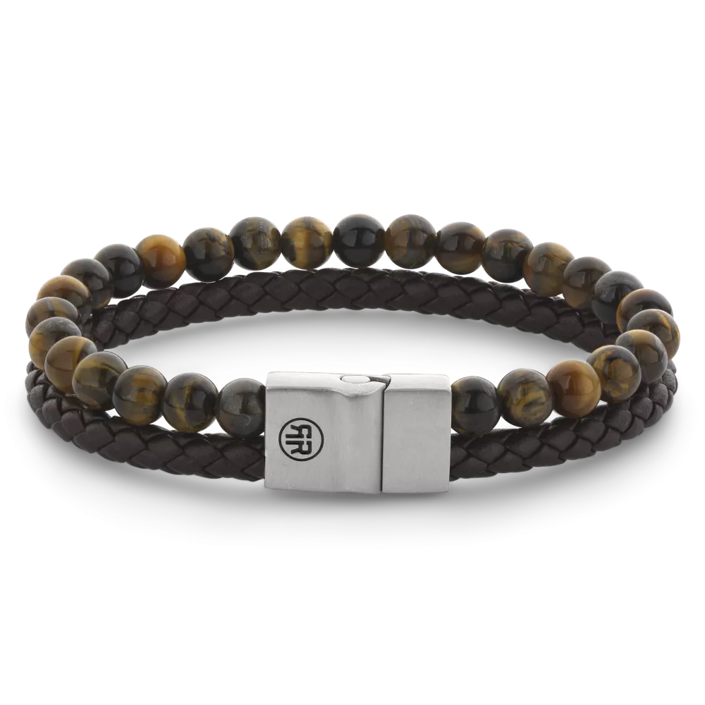 Deze Full Metal armband van Rebel and Rose is een combinatie armband van leer en beads die samenkomen in een 12 mm brede edelstalen sluiting. De kralen (Tijgeroog) zijn 6mm en de leren band is 5mm breed. De unieke (PSR*) sluiting bestaat uit twee delen die perfect in elkaar vallen, zonder dat daar hulpmiddelen als magneten voor nodig zijn. Meet je polsomtrek op en kijk in de maattabel voor de juiste keuze.